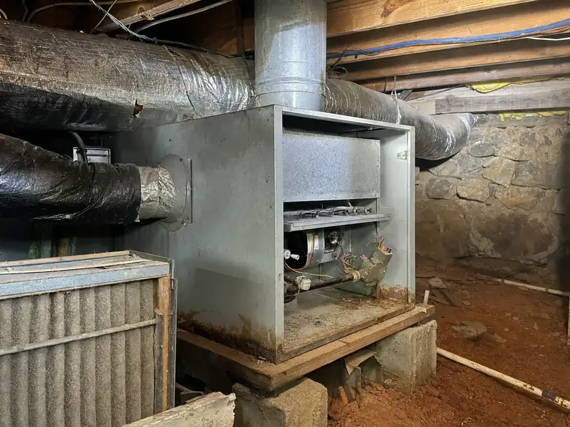 An aging propane furnace and its metal B-vent flue in a Pickens County crawlspace, the vintage that quietly wastes a fifth of every gallon