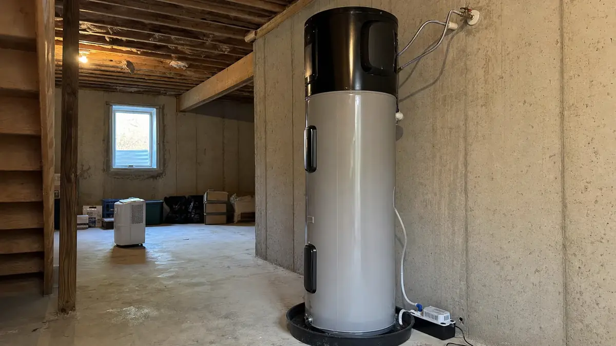 A hybrid heat pump water heater newly set in an open mountain-home basement with the room volume its compressor needs
