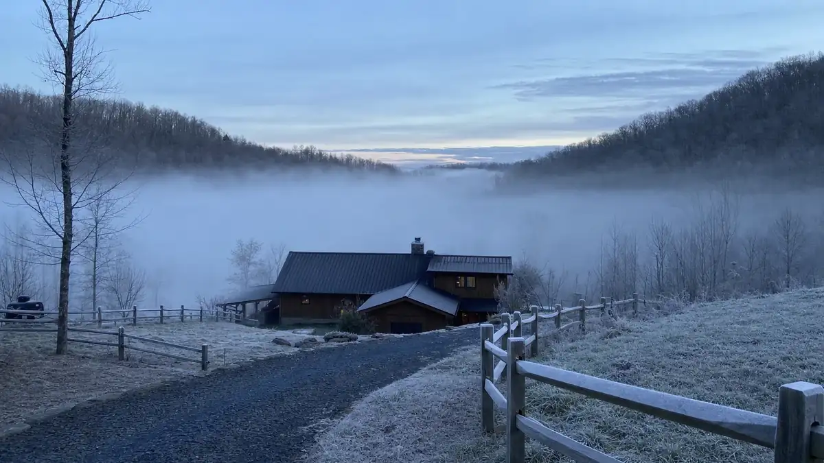 Cold-air drainage settling in a Marble Hill hollow at dawn, the microclimate that makes local design temperature lower than the forecast