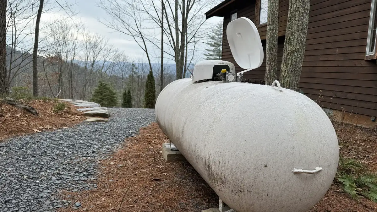 Frost on the dome gauge of a residential propane tank behind a North Georgia home, the moment homeowners start pricing electric heat instead