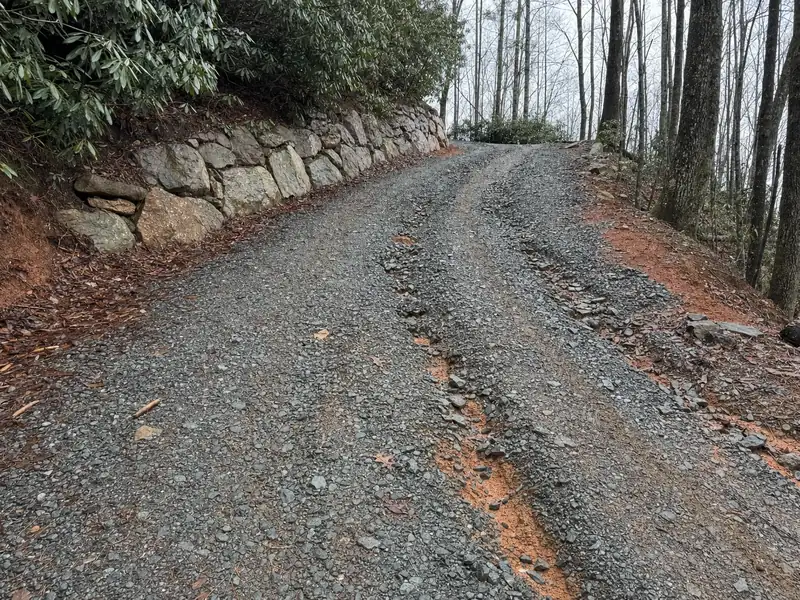 The steep crushed-gravel drive that decides whether a tank collection truck can reach a Pickens County property before winter closes in