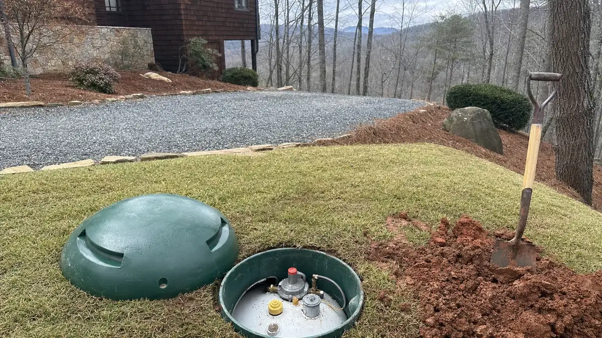 The dome lid of a buried propane tank opened in a North Georgia yard ahead of removal or code-compliant abandonment in place
